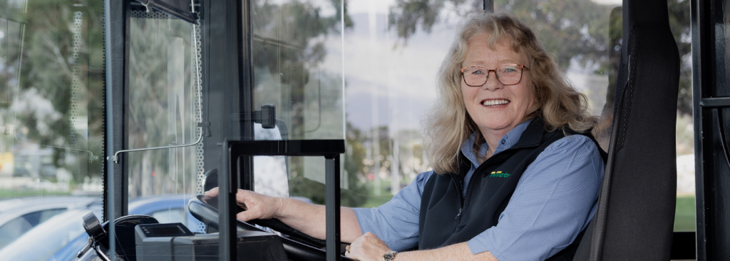 Female bus driver smiling