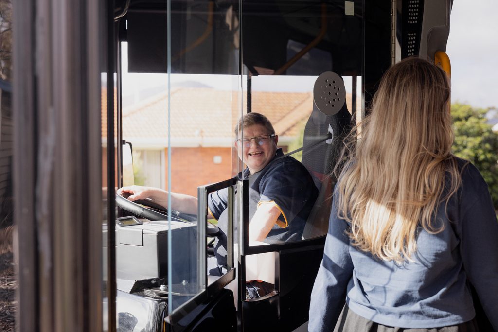 Bus operator smiles as customer boards